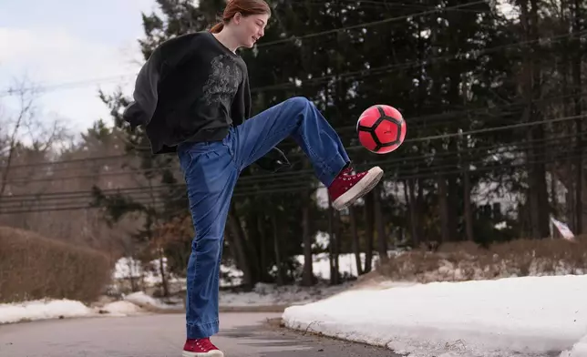 FILE - Parker Tirrell, a transgender athlete who plays on her high school's girls soccer team, practices in the driveway of her family home, Friday, March 7, 2025, in Plymouth, N.H. (AP Photo/Charles Krupa, File)