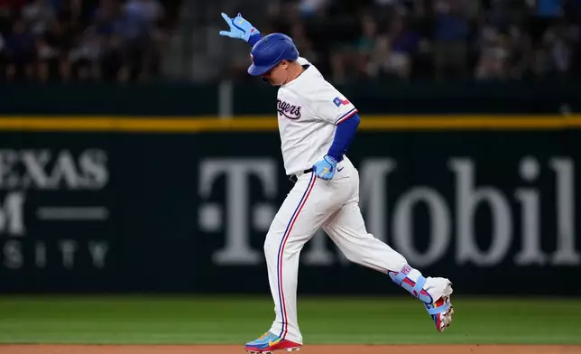 Texas Rangers' Joc Pederson celebrates his solo home run in the first inning of a baseball game against the Seattle Mariners in Arlington, Texas, Monday, July 27, 2026. (AP Photo/Tony Gutierrez)