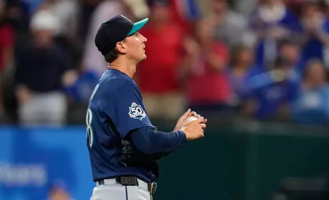 Seattle Mariners pitcher George Kirby stands behind the mound after giving up a two-run home run to Texas Rangers' Jake Burger in the third inning of a baseball game in Arlington, Texas, Monday, July 27, 2026. (AP Photo/Tony Gutierrez)