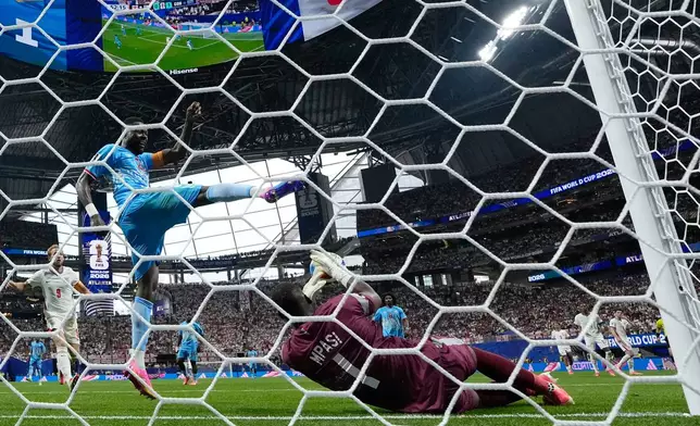 Congo goalkeeper Lionel Mpasi (1) makes a save under Congo's Chancel Mbemba (22) during the World Cup round of 32 soccer match between England and Congo in Atlanta, Wednesday, July 1, 2026. (AP Photo/Erik S. Lesser)