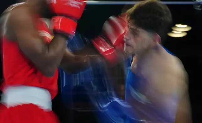 Pakistan's Afzal Khan, right, and Jovanie Bouzin of Seychelles, compete during the Men's 65kg round of 32 boxing bout during the Commonwealth Games in Glasgow, Scotland, Friday, July 24, 2026. (AP Photo/Kin Cheung)