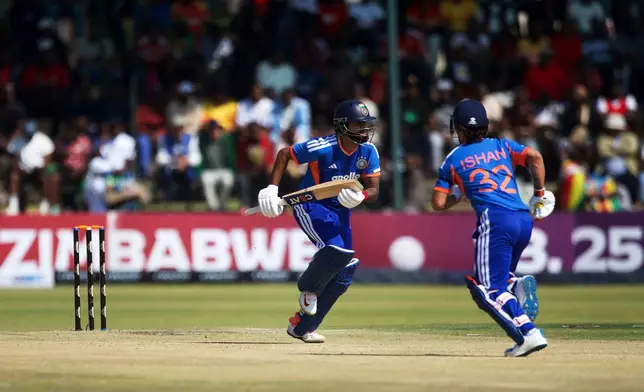 India's captain Shreyas Iyer, left, with his batting partner Ishan Kishan run between the wickets during the second T20 cricket match between Zimbabwe and India in Harare, Zimbabwe, Saturday, July 25, 2026. (AP Photo/Wonder Mashura)