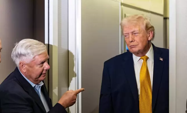 FILE - Sen. Lindsey Graham, R-S.C., left, gestures as President Donald Trump speaks with reporters while in flight on Air Force One, Jan. 4, 2026, as they were returning to Joint Base Andrews, Md. (AP Photo/Alex Brandon, File)