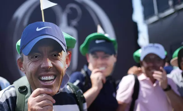 Golf fans with masks of Rory McIlroy, of Northern Ireland, pose near the 1st tee during the first day of the British Open Golf championships at Royal Birkdale golf club, in Southport, England, Thursday, July 16, 2026. (AP Photo/Jon Super)