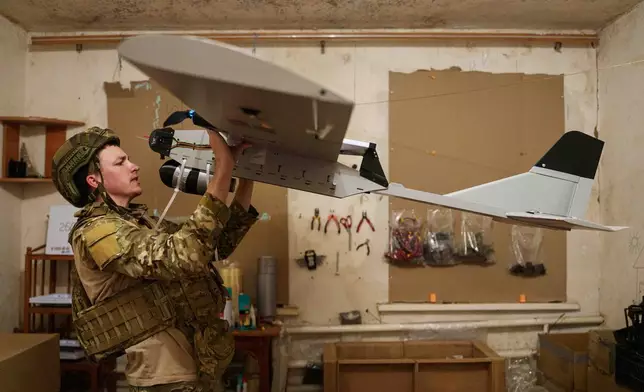 A serviceman with Ukraine’s K-2 brigade prepares a midrange drone before flying it toward Russian positions on the front line in Ukraine’s Donetsk region on June 22, 2026. (AP Photo/Evgeniy Maloletka)