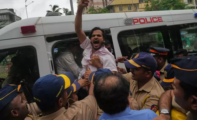 Police detain a supporter of the Cockroach Janta Party during a protest demanding the resignation of India's education minister in Mumbai, India, Monday, July 20, 2026.(AP Photo/Rafiq Maqbool)