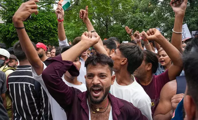 Supporters of the Cockroach Janta Party shout anti government slogans as they they attempt to march toward India's Parliament, demanding the resignation of the education minister, in New Delhi, India, Monday, July 20, 2026. (AP Photo/Manish Swarup)