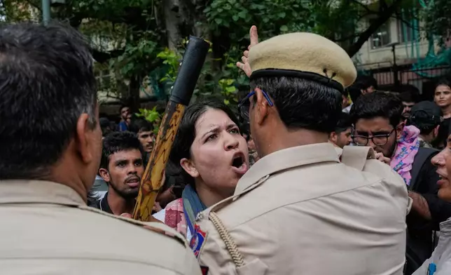 Supporters of the Cockroach Janta Party scuffle with police as they attempt to march toward India's Parliament, demanding the resignation of the education minister, in New Delhi, India, Monday, July 20, 2026. (AP Photo/Manish Swarup)