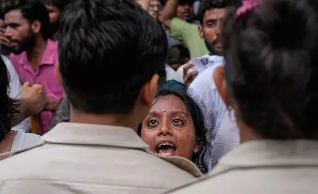 A supporter of the Cockroach Janta Party confront police officers as protesters attempt to march toward India's Parliament, demanding the resignation of the education minister, in New Delhi, India, Monday, July 20, 2026. (AP Photo/Manish Swarup)