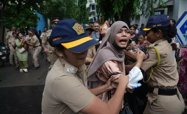 Police officers detain supporters of the Cockroach Janta Party during a protest demanding the resignation of India's education minister in Mumbai, India, Monday, July 20, 2026. (AP Photo/Rafiq Maqbool)