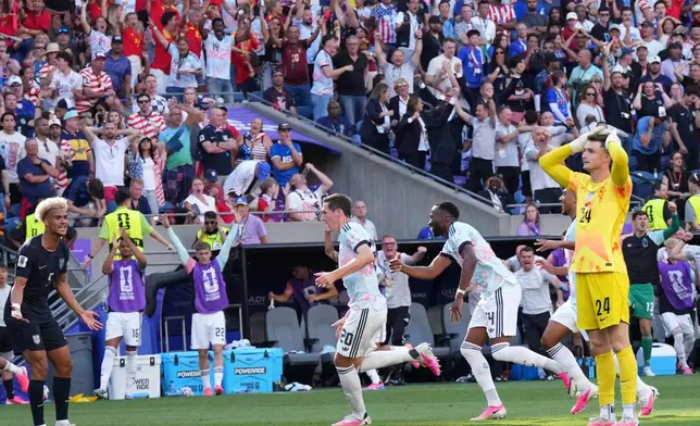 United States goalkeeper Matt Freese (24) and United States' Antonee Robinson (5) react after Belgium's Hans Vanaken (20) scored their third goal during the World Cup round of 16 soccer match between the United States and Belgium in Seattle, Monday, July 6, 2026. (AP Photo/Ted S. Warren)
