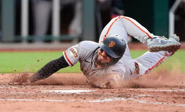 San Francisco Giants' Jesus Rodriguez slides home to score on a single by Drew Gilbert during the fifth inning of a baseball game against the Kansas City Royals, Tuesday, July 21, 2026, in Kansas City, Mo. (AP Photo/Charlie Riedel)