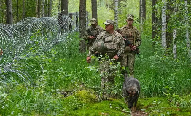 Ukrainian border guards patrol Ukraine-Belarus border in an undisclosed location in Ukraine Tuesday, July 7, 2026. (AP Photo/Efrem Lukatsky)