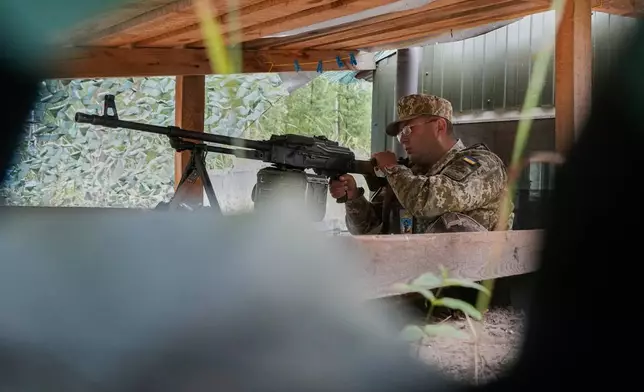 A Ukrainian border guard is on duty at the Ukraine-Belarus border in an undisclosed location in Ukraine Tuesday, July 7, 2026. (AP Photo/Efrem Lukatsky)