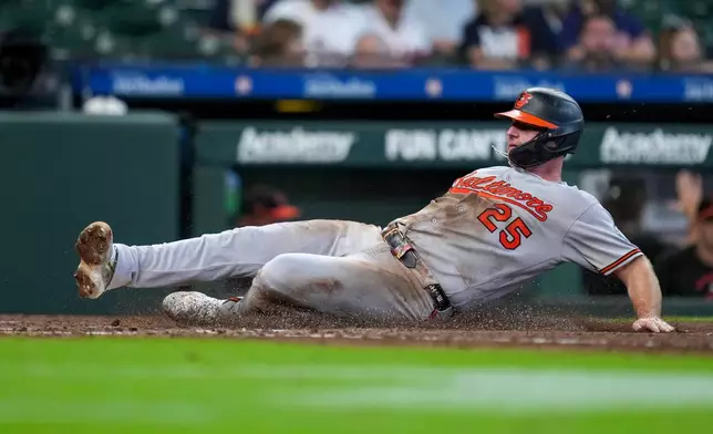 Baltimore Orioles' Pete Alonso slides to score on a two-run single hit by Leody Taveras during the fifth inning of a baseball game against the Houston Astros, Sunday, July 19, 2026, in Houston. (AP Photo/Eric Christian Smith)