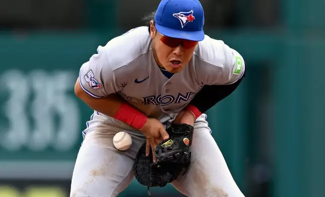 Toronto Blue Jays first baseman Kazuma Okamoto blocks a ground ball before putting out Washington Nationals' Daylen Lile during the second inning of a baseball game, Wednesday, July 29, 2026, in Washington. (AP Photo/John McDonnell)