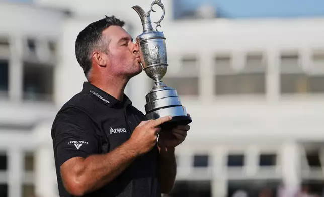 Ryan Fox of New Zealand poses with the Claret Jug trophy in front of the club house, after winning the British Open Golf championships at Royal Birkdale golf club, in Southport, England, Sunday, July 19, 2026. (AP Photo/Jon Super)