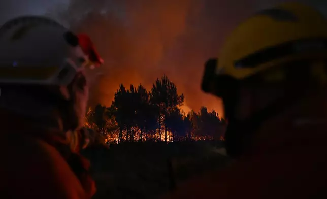 Firefighters battle a blaze outside Lanton, during wildfires in southwestern France, Tuesday, July 28, 2026. (AP Photo/Emma Da Silva)