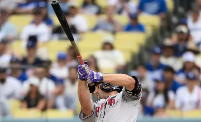 Arizona Diamondbacks' Ryan Waldschmidt hits a sacrifice fly during the fifth inning of a baseball game against the Los Angeles Dodgers in Los Angeles, Sunday, July 12, 2026. (AP Photo/Kyusung Gong)