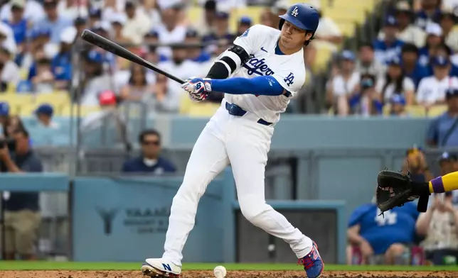 Los Angeles Dodgers' Shohei Ohtani hits a ground ball during the fifth inning of a baseball game against the Arizona Diamondbacks in Los Angeles, Sunday, July 12, 2026. (AP Photo/Kyusung Gong)