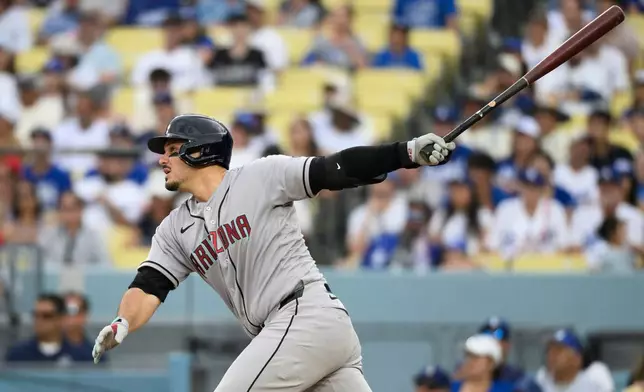 Arizona Diamondbacks' Nolan Arenado watches his RBI double during the fifth inning of a baseball game against the Los Angeles Dodgers in Los Angeles, Sunday, July 12, 2026. (AP Photo/Kyusung Gong)