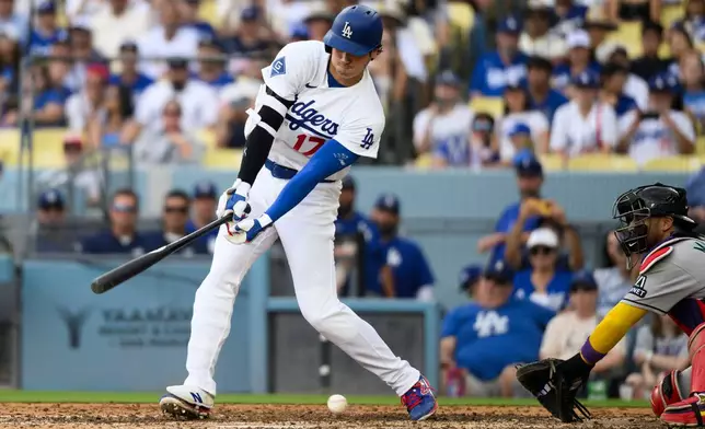 Los Angeles Dodgers' Shohei Ohtani swings and misses for a strikeout during the seventh inning of a baseball game against the Arizona Diamondbacks in Los Angeles, Sunday, July 12, 2026. (AP Photo/Kyusung Gong)