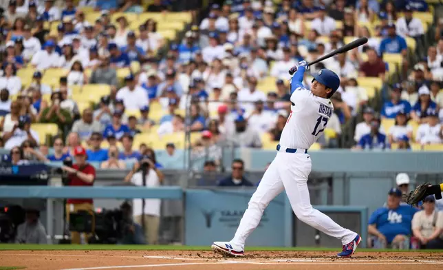 Los Angeles Dodgers' Shohei Ohtani hits a solo home run during the first inning of a baseball game against the Arizona Diamondbacks in Los Angeles, Sunday, July 12, 2026. (AP Photo/Kyusung Gong)