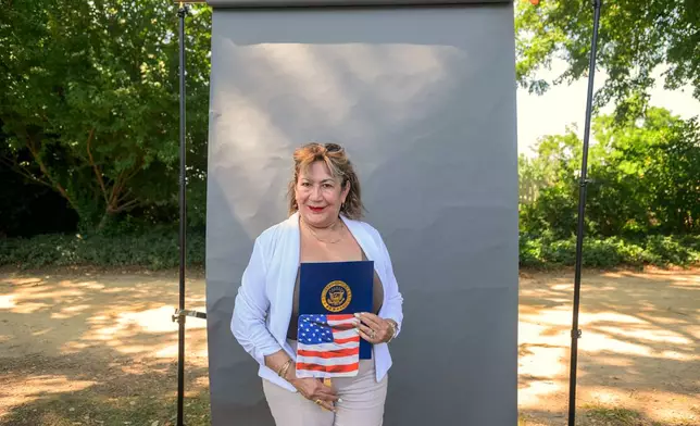 New U.S. citizen Martha Flores de Martinez, from El Salvador, poses for a portrait following a naturalization ceremony on Independence Day at George Washington's Mount Vernon, Saturday, July 4, 2026, in Alexandria, Va. (AP Photo/Rod Lamkey, Jr.)