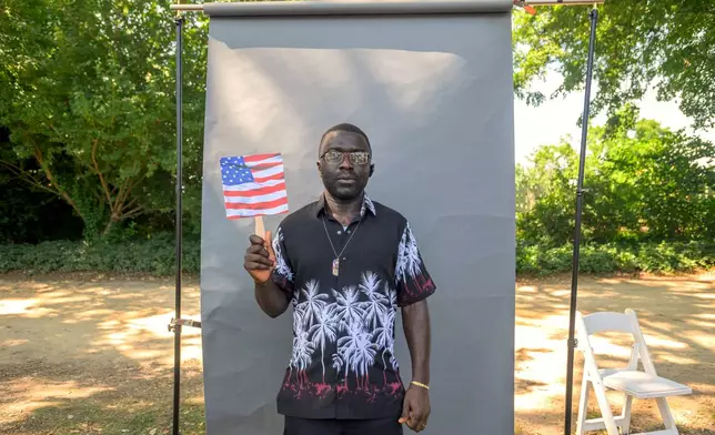 New U.S. citizen Tebid Munghey John-Paul, from Cameroon, poses for a portrait following a naturalization ceremony on Independence Day at George Washington's Mount Vernon, Saturday, July 4, 2026, in Alexandria, Va. (AP Photo/Rod Lamkey, Jr.)