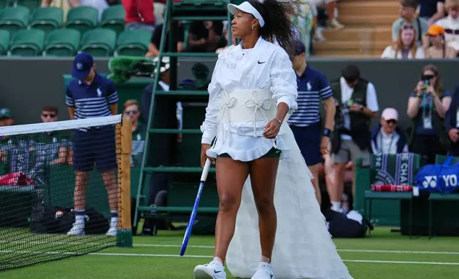 Naomi Osaka of Japan enters the court for the second round women's singles match against Anastasia Gasanova of Russia at the Wimbledon Tennis Championships in London, Wednesday, July 1, 2026.(AP Photo/Kirsty Wigglesworth)