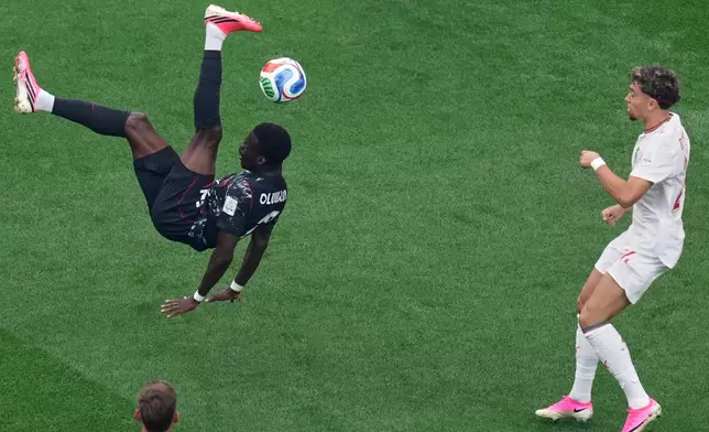 Canada's Tani Oluwaseyi (12) attempts a shot during the World Cup round of 16 soccer match between Canada and Morocco in Houston, Saturday, July 4, 2026. (AP Photo/Eric Smith