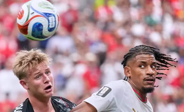 Canada's Luc de Fougerolles, left, and Morocco's Redouane Halhal vie for the ball during the World Cup round of 16 soccer match between Canada and Morocco in Houston, Saturday, July 4, 2026. (AP Photo/Eric Gay)