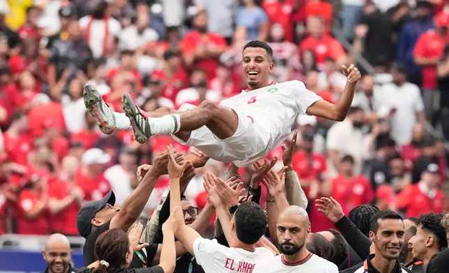 Morocco's Azzedine Ounahi is thrown in the air by his teammates after the World Cup round of 16 soccer match against Canada in Houston, Saturday, July 4, 2026. (AP Photo/David J. Phillip)