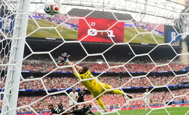 Morocco's Azzedine Ounahi (8) scores their second goal past Canada goalkeeper Maxime Crepeau (16) during the World Cup round of 16 soccer match between Canada and Morocco in Houston, Saturday, July 4, 2026. (AP Photo/David J. Phillip)