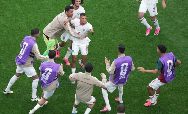 Morocco players celebrate after the first goal during the World Cup round of 16 soccer match between Canada and Morocco in Houston, Saturday, July 4, 2026. (AP Photo/Eric Smith