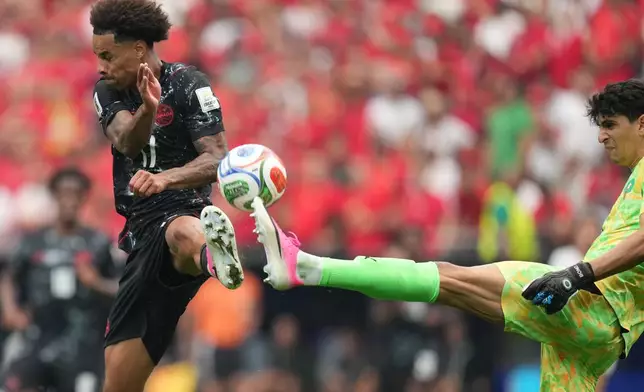 Morocco goalkeeper Yassine Bounou, right, and Canada's Tajon Buchanan fight for the ball during the World Cup round of 16 soccer match between Canada and Morocco in Houston, Saturday, July 4, 2026. (AP Photo/Eric Gay)