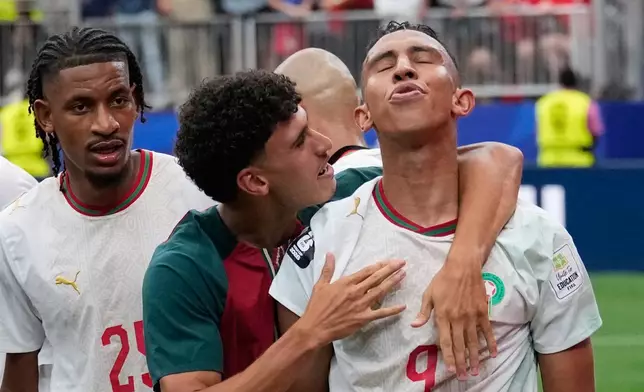 Morocco's Soufiane Rahimi, right, is congratulated by teammates after scoring his side's 3rd goal against Canada during the World Cup round of 16 soccer match in Houston, Saturday, July 4, 2026. (AP Photo/David J. Phillip)