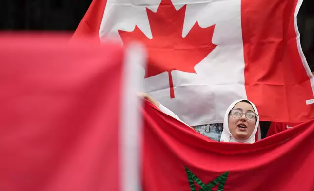 A fan holds a flag of Morocco prior to the World Cup round of 16 soccer match between Canada and Morocco in Houston, Saturday, July 4, 2026. (AP Photo/Eric Gay)