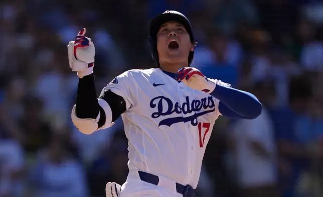 Los Angeles Dodgers' Shohei Ohtani yells as he loses his bat during the third inning of a baseball game against the San Diego Padres, Sunday, July 5, 2026, in Los Angeles. (AP Photo/Mark J. Terrill)