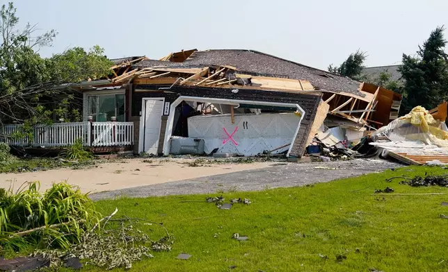 A view of a home damaged by a tornado that tore through a day before in Appleton, Wis., Tuesday, July 28, 2026. (AP Photo/Kayla Wolf)