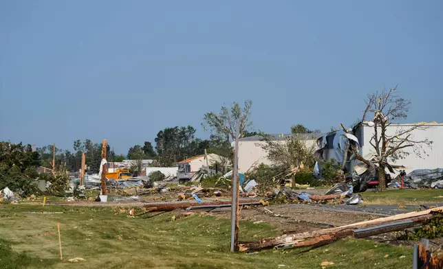 Debris and fallen trees cover the ground after a tornado struck the day before, Tuesday, July 28, 2026, in Appleton, Wis. (AP Photo/Kayla Wolf)