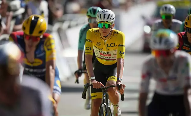 Slovenia's Tadej Pogacar, wearing the overall leader's yellow jersey crosses the finish line of the eighteenth stage of the Tour de France cycling race, with start in Voiron and finish in Orcieres-Merlette, France, Thursday, July 23, 2026. (AP Photo/Mosa'ab Elshamy)