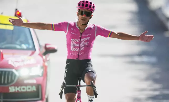 Ecuador's Richard Carapaz celebrates as he crosses the finish line to win the eighteenth stage of the Tour de France cycling race, with start in Voiron and finish in Orcieres-Merlette, France, Thursday, July 23, 2026. (AP Photo/Mosa'ab Elshamy)