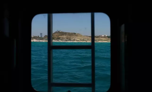 A military firing range that had been used for decades and is slated to be cleared and opened for public use, is visible through a boat in the Mediterranean Sea in off the coast of Rishon Lezion, Israel, Sunday, June 21, 2026. (AP Photo/Ariel Schalit)
