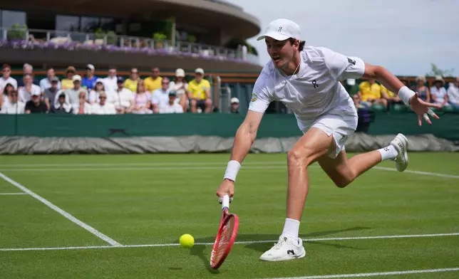 Joao Fonseca of Brazil reaches to return the ball to Roberto Bautista Agut of Spain in their first round men's singles match at the Wimbledon Tennis Championships in London, Monday, June 29, 2026. (AP Photo/Maja Smiejkowska)
