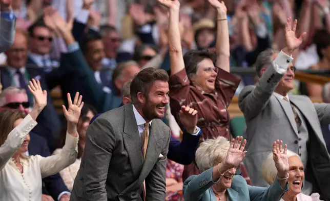 Soccer legend David Beckham and his mother Sandra Georgina Beckham react during the men's singles match between Jannik Sinner of Italy and Miomir Kecmanovic of Serbia at the Wimbledon Tennis Championships in London, Monday, June 29, 2026.((AP Photo/Kin Cheung)