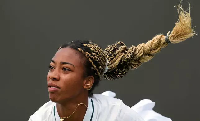 Tyra Caterina Grant of Italy plays a return to Katie Boulter of Britain during their women's singles match at the Wimbledon Tennis Championships in London, Tuesday, June 30, 2026. (AP Photo/Kin Cheung)