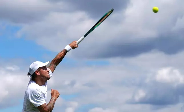 Alex Molcan of Slovakia serves the ball during the men's singles match against Daniel Altmaier of Germany at the Wimbledon Tennis Championships in London, Wednesday, July 1, 2026.(AP Photo/Kirsty Wigglesworth)