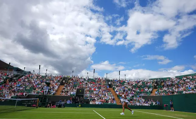 Naomi Osaka of Japan returns the ball during the second round women's singles match against Anastasia Gasanova of Russia at the Wimbledon Tennis Championships in London, Wednesday, July 1, 2026.(AP Photo/Kirsty Wigglesworth)