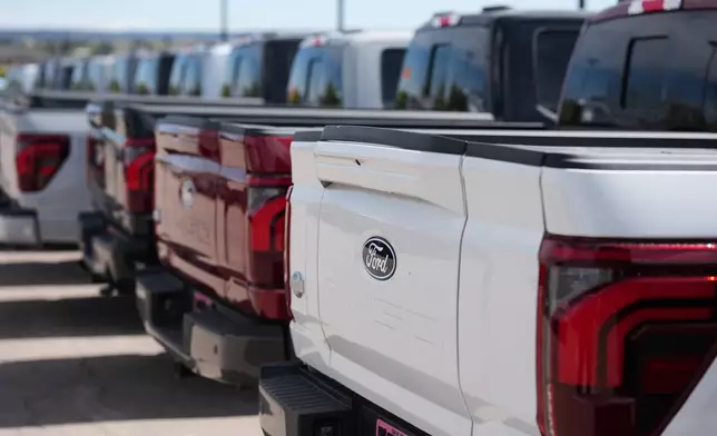 FILE - Unsold 2026 F-150 pickup trucks sit in a long line outside a Ford agency April 12, 2026, in Centennial, Colo. (AP Photo/David Zalubowski, File)